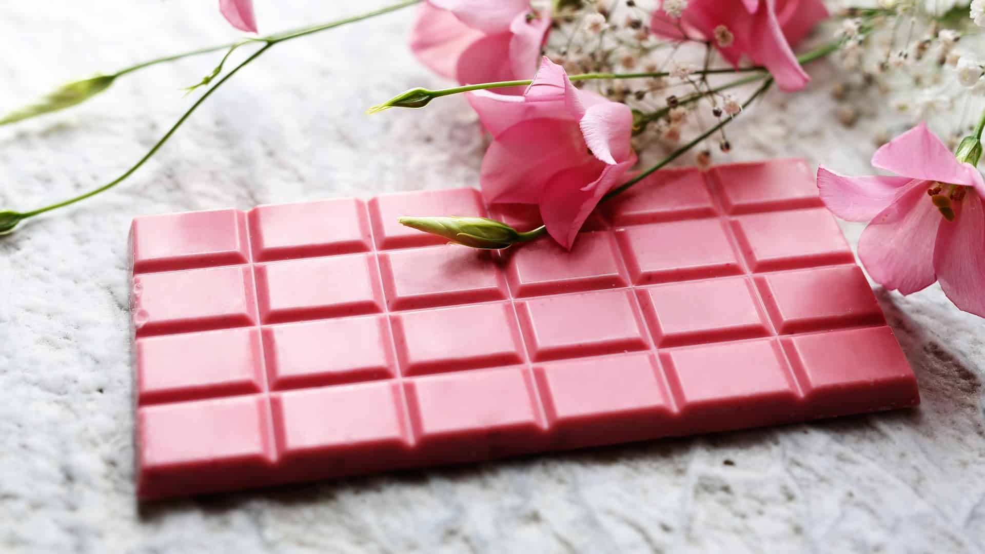 Ruby chocolate bar next to pink flowers